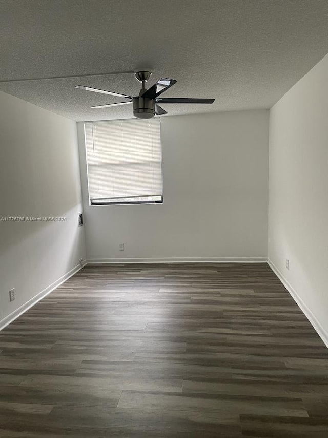 unfurnished room with dark wood-type flooring, a textured ceiling, and ceiling fan