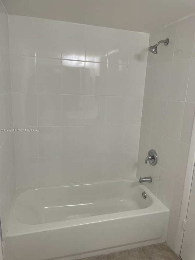 bathroom with tile patterned flooring and tiled shower / bath