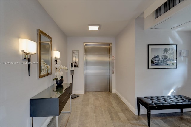 hall featuring light hardwood / wood-style floors and elevator