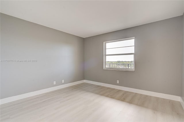 spare room featuring light hardwood / wood-style flooring