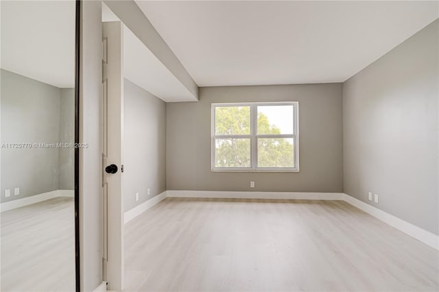 spare room featuring light hardwood / wood-style flooring