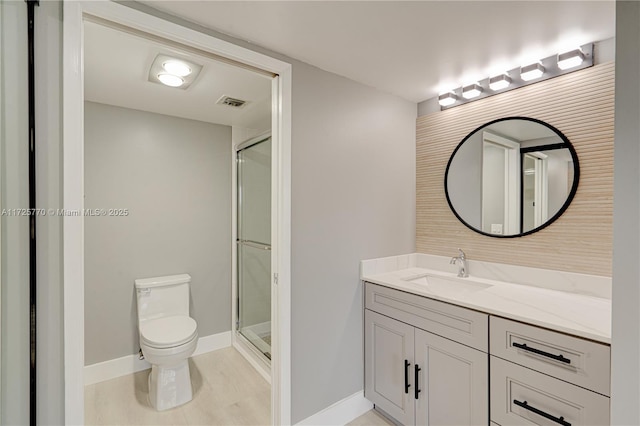 bathroom with toilet, tile patterned floors, walk in shower, and vanity