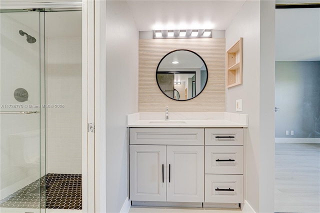 bathroom featuring an enclosed shower and vanity