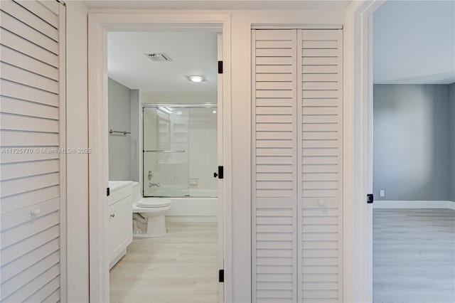 hallway with light hardwood / wood-style floors