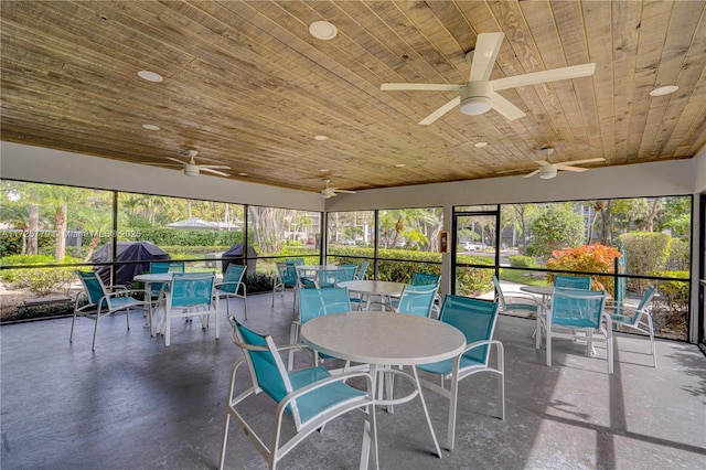 sunroom featuring ceiling fan and wood ceiling