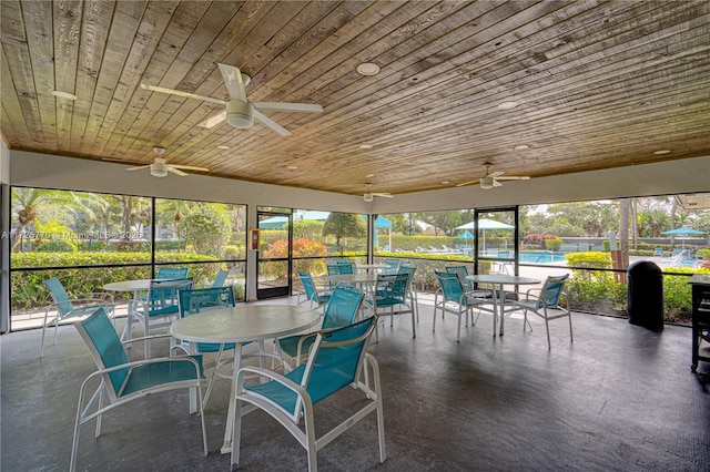 sunroom / solarium with wooden ceiling and ceiling fan