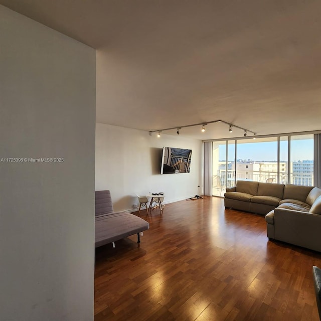 living room with track lighting and hardwood / wood-style flooring