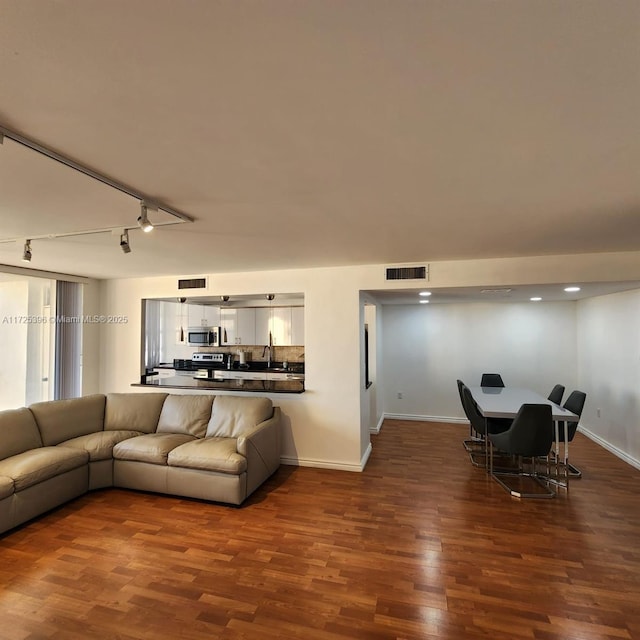 living room featuring track lighting and wood-type flooring