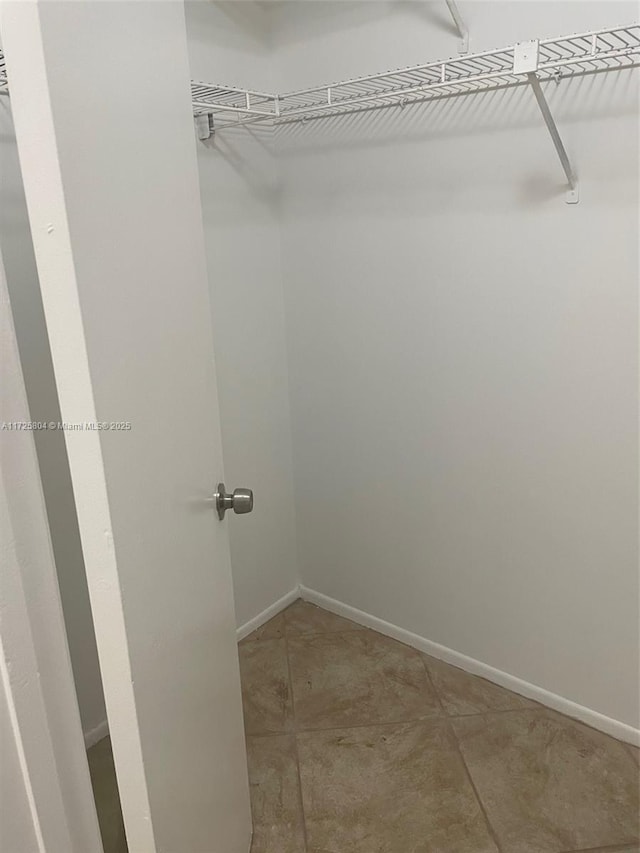 spacious closet with tile patterned floors