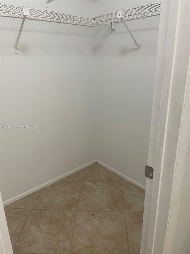 spacious closet with tile patterned flooring