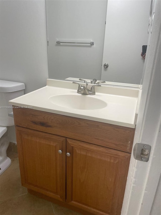 bathroom featuring tile patterned floors, vanity, and toilet