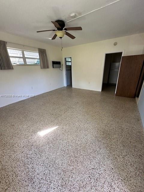 interior space with ceiling fan