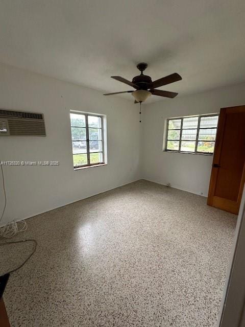 empty room with ceiling fan and a wall mounted AC