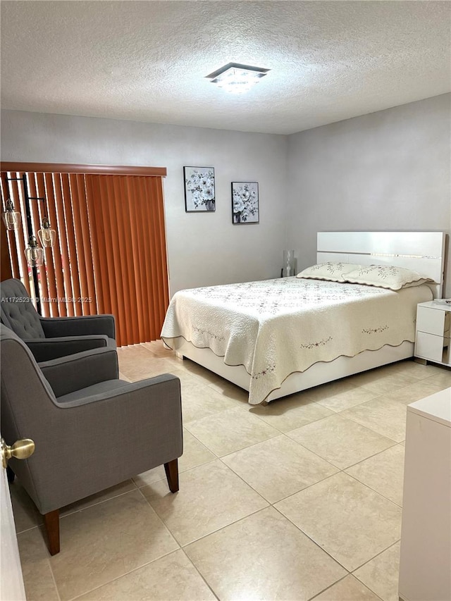 tiled bedroom featuring a textured ceiling
