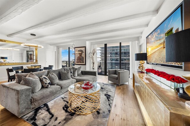 living room with an inviting chandelier, beam ceiling, and wood-type flooring