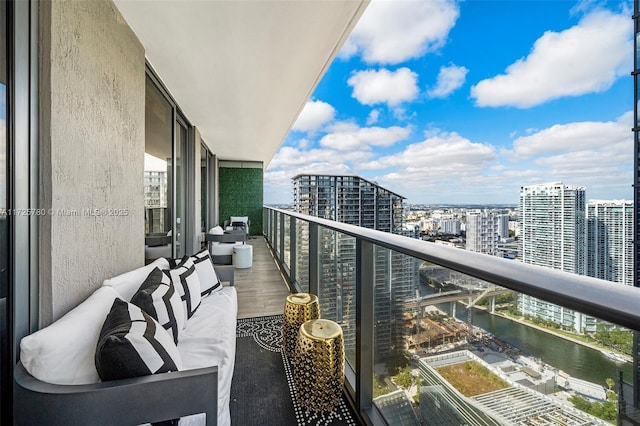 balcony with a water view and outdoor lounge area