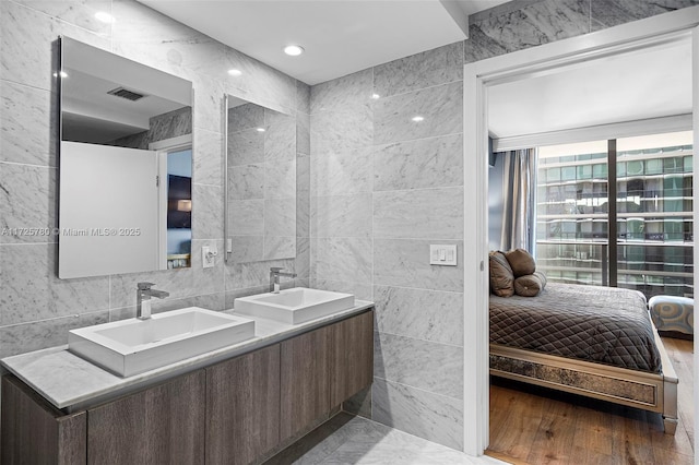 bathroom featuring tile walls and vanity