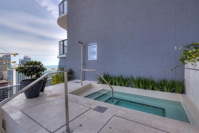 view of swimming pool featuring a community hot tub