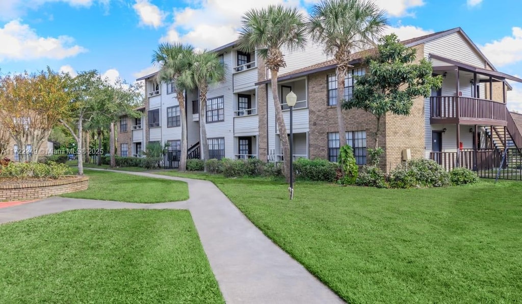 view of property's community with a lawn