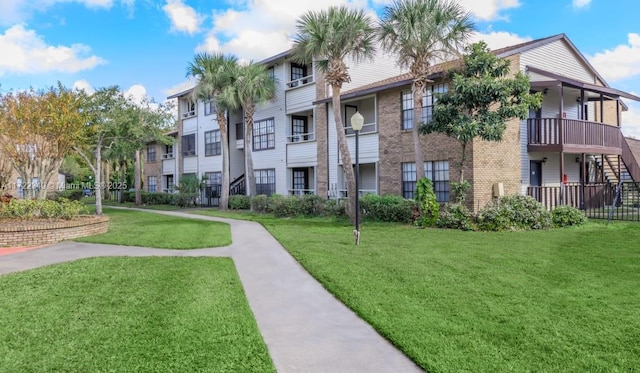 view of property's community with a lawn