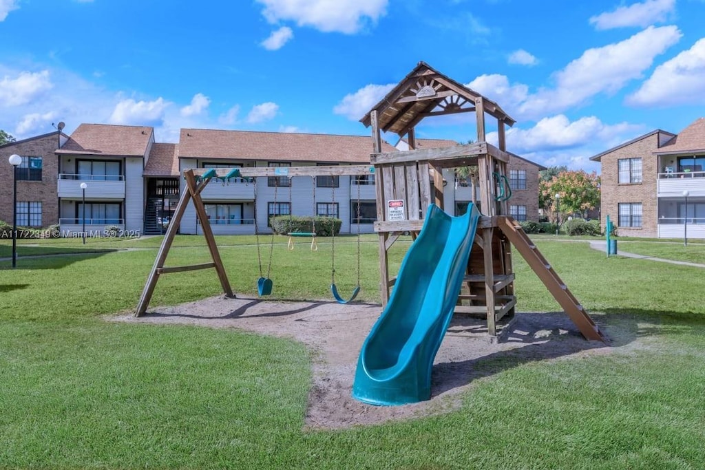 view of jungle gym featuring a lawn