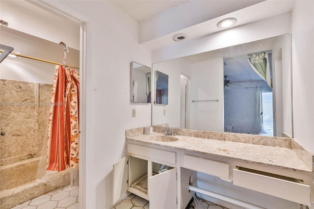 bathroom with a ceiling fan, curtained shower, and vanity