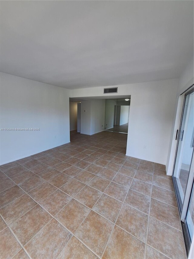 bathroom featuring shower / tub combo, stacked washer and clothes dryer, toilet, and tile patterned floors