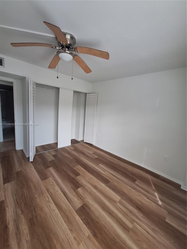 unfurnished bedroom with dark wood-type flooring and ceiling fan