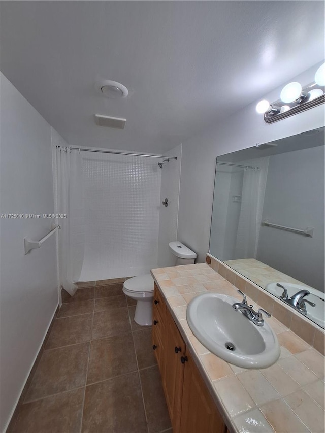 full bathroom featuring a shower with curtain, vanity, toilet, and tile patterned floors