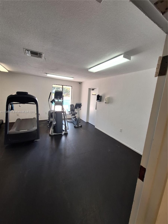 workout area with a textured ceiling