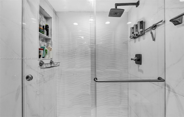 bathroom featuring a shower with shower door