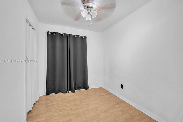 unfurnished room featuring ceiling fan and light wood-type flooring