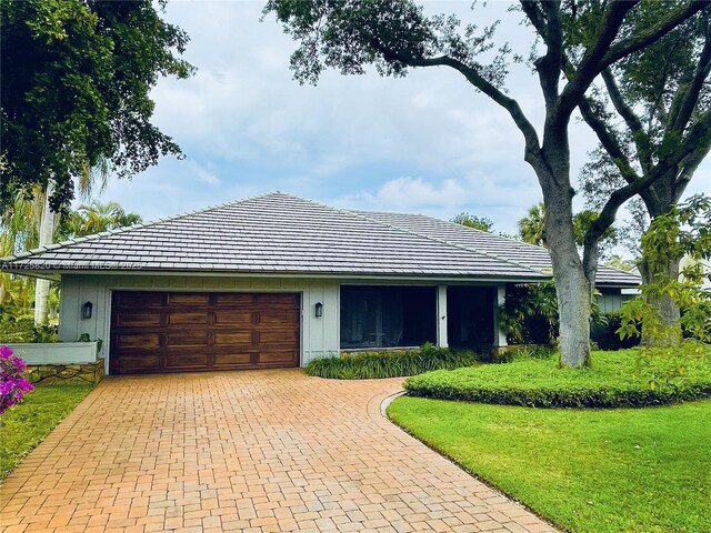 1 E Balfour Rd E, Palm Beach Gardens, FL 33418 - view of front facade with a garage, decorative driveway, and a front lawn