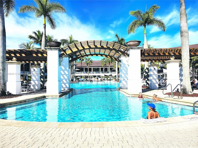 community pool featuring a pergola