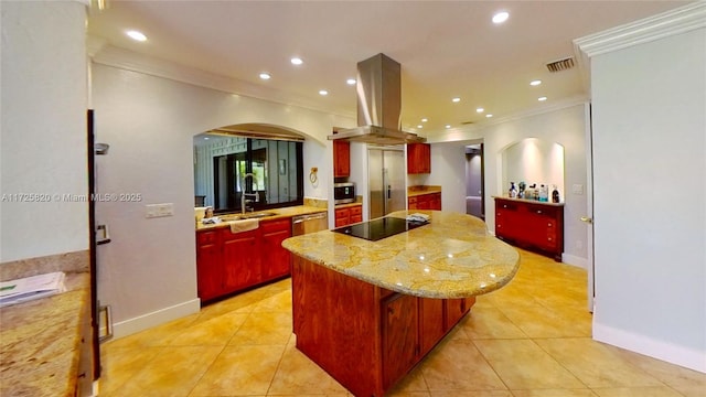 kitchen with arched walkways, island exhaust hood, stainless steel appliances, visible vents, and a kitchen island