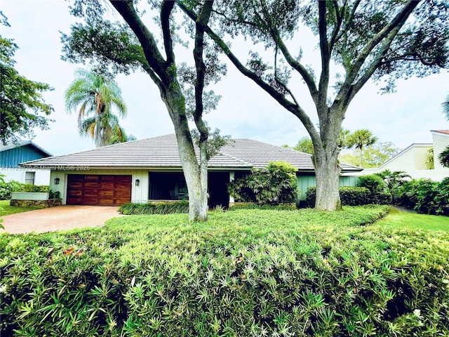 1 E Balfour Rd E, Palm Beach Gardens, FL 33418 - ranch-style home featuring an attached garage, a tiled roof, and driveway