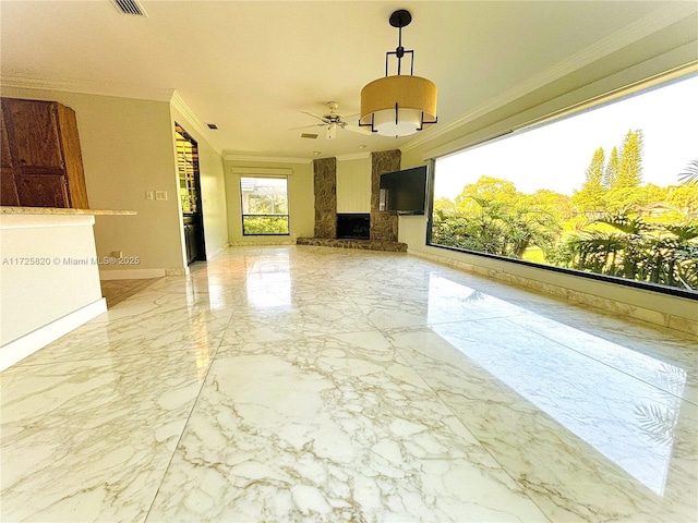 unfurnished living room featuring a fireplace, ceiling fan, and crown molding