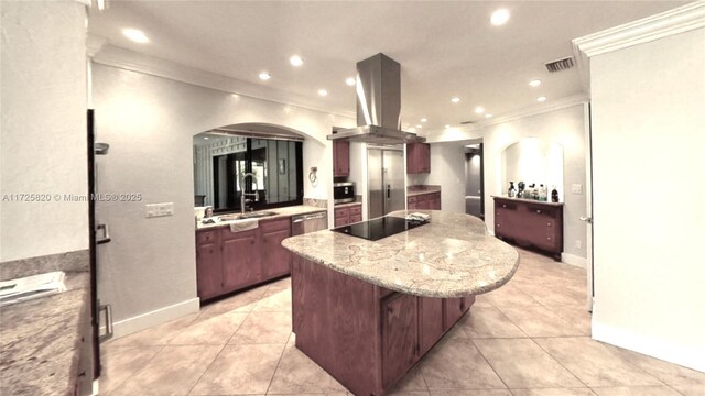 kitchen featuring island exhaust hood, a kitchen island, crown molding, appliances with stainless steel finishes, and ceiling fan