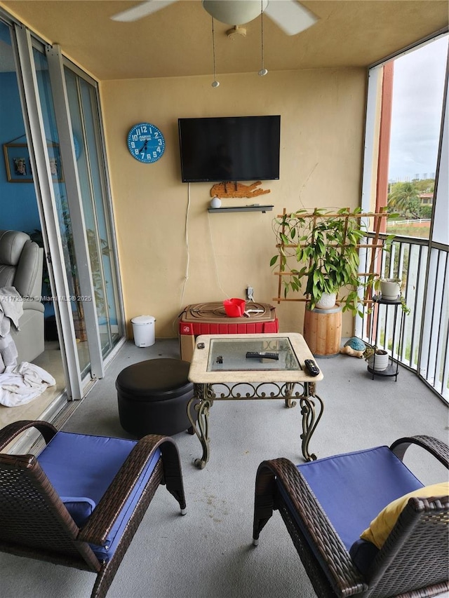 interior space with a balcony and ceiling fan