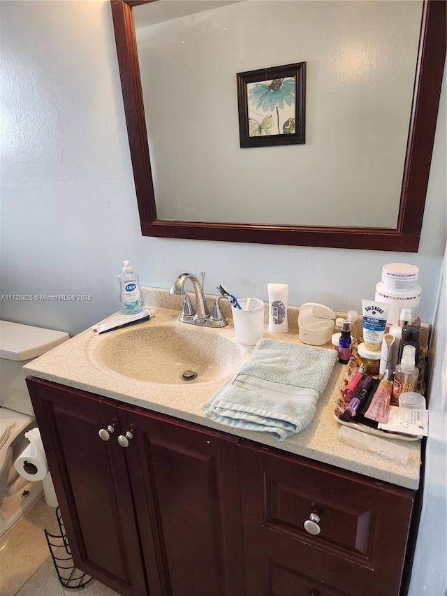 bathroom with tile patterned floors, vanity, and toilet