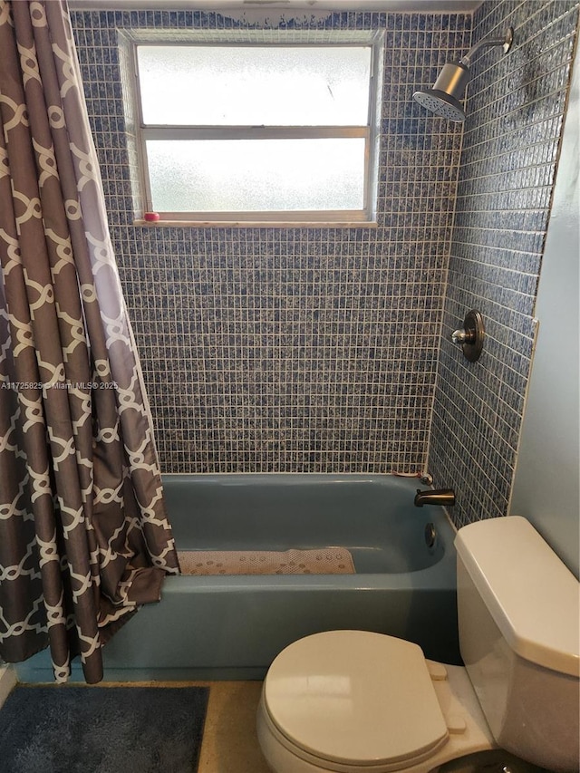 bathroom featuring toilet and shower / bath combination with curtain