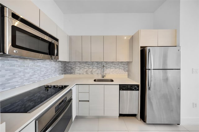 kitchen with a sink, light countertops, tasteful backsplash, and stainless steel appliances