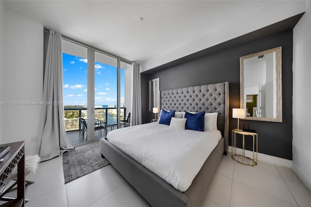 tiled bedroom with access to outside, baseboards, and expansive windows