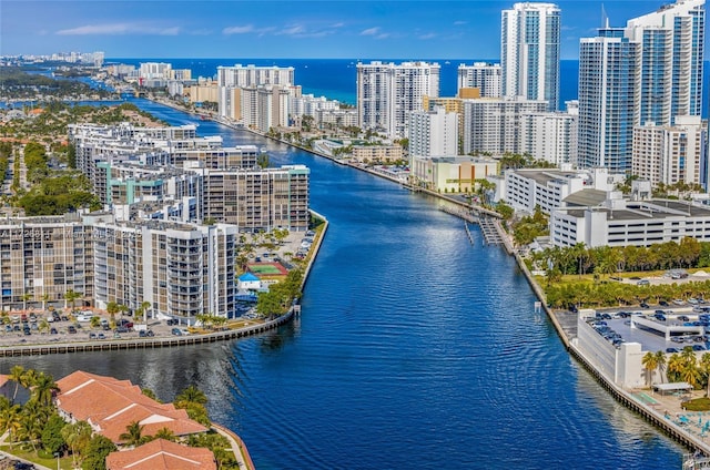 birds eye view of property featuring a city view and a water view