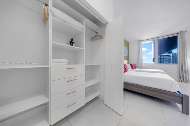 spacious closet with light tile patterned floors