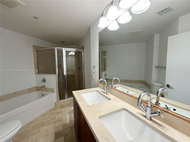 bathroom featuring visible vents, a sink, and toilet