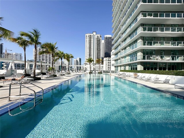 pool with a patio area and a city view