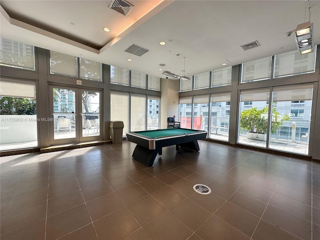 recreation room featuring a healthy amount of sunlight and visible vents
