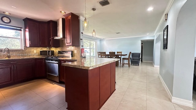 kitchen featuring wall chimney range hood, kitchen peninsula, sink, stainless steel appliances, and light tile patterned floors