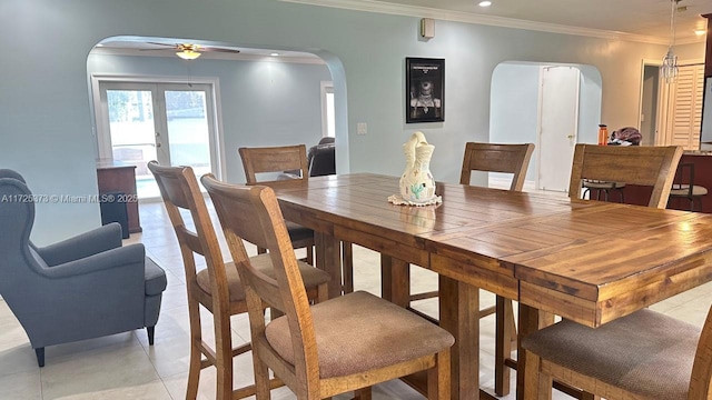 dining room with ceiling fan, light tile patterned floors, crown molding, and french doors